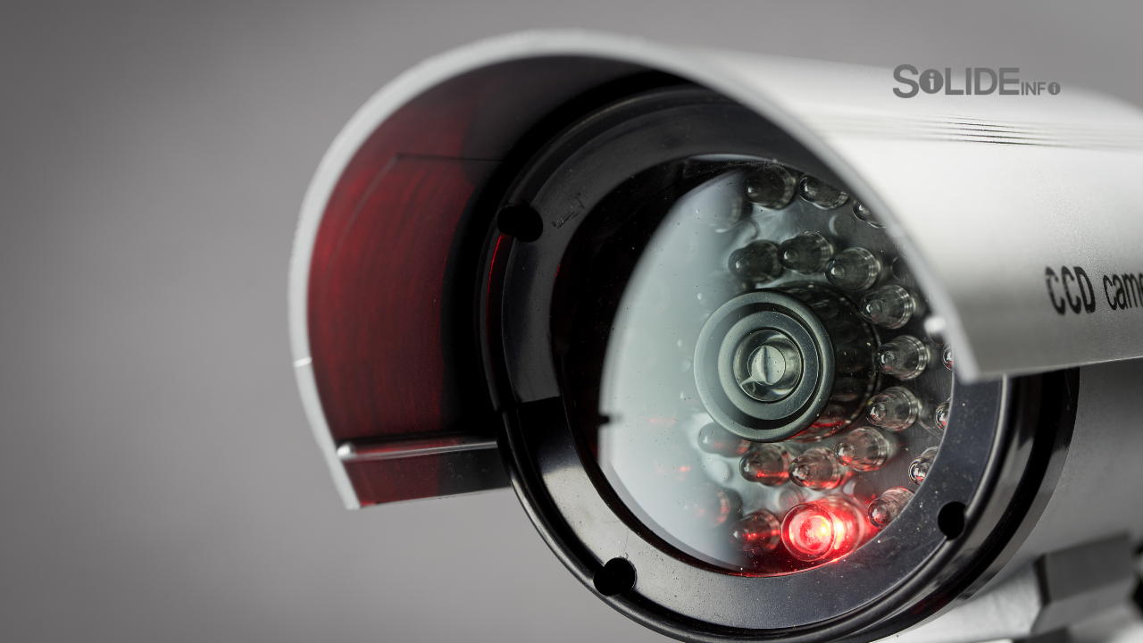 A small office building with security cameras and a security alarm sign, representing business security.