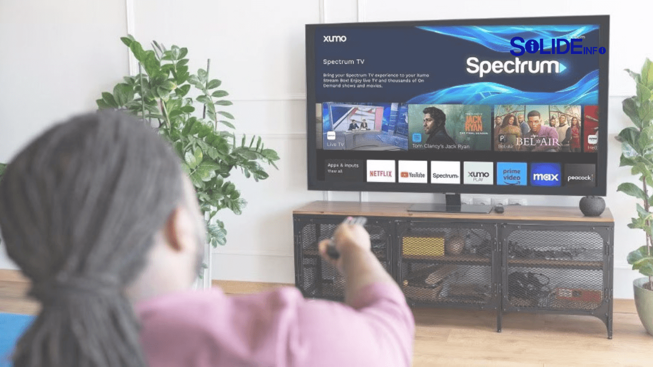 A person streaming live TV on a laptop with the Spectrum logo in the background, demonstrating how to watch spectrum live content anywhere.